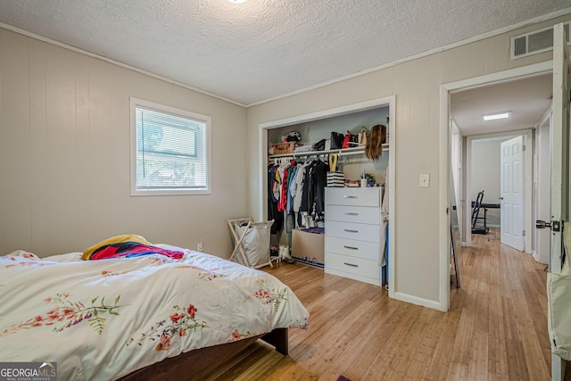 3710 Lynn Dr, Powder Springs, GA 30127 - bedroom featuring a closet, visible vents, light wood finished floors, and ornamental molding