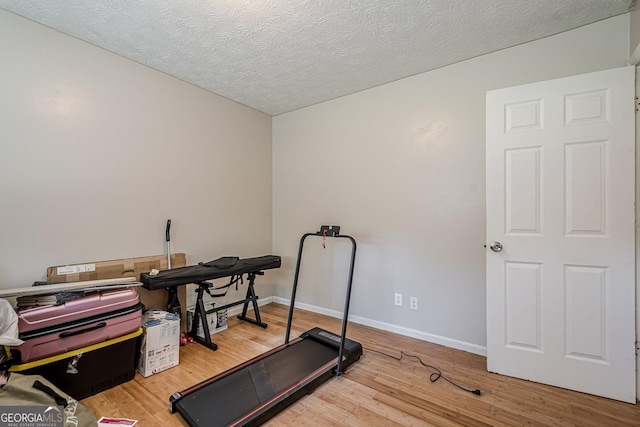 3710 Lynn Dr, Powder Springs, GA 30127 - workout room with wood finished floors, a textured ceiling, and baseboards