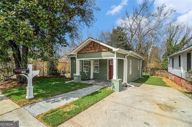 bungalow-style home with a front yard