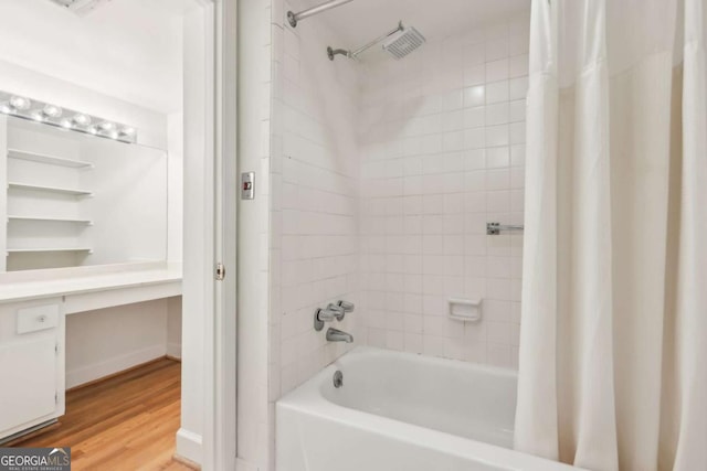 bathroom featuring hardwood / wood-style floors and shower / bath combination with curtain