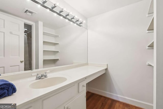 bathroom with vanity and hardwood / wood-style floors