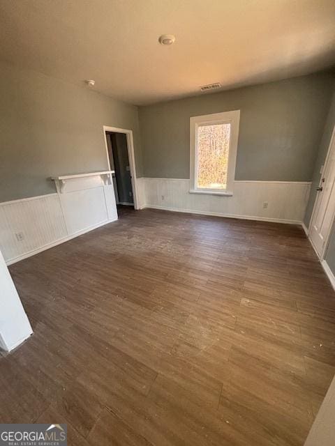 empty room with dark hardwood / wood-style flooring