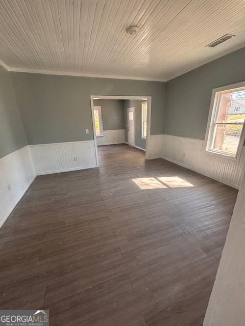 spare room with crown molding, dark hardwood / wood-style floors, and wooden ceiling