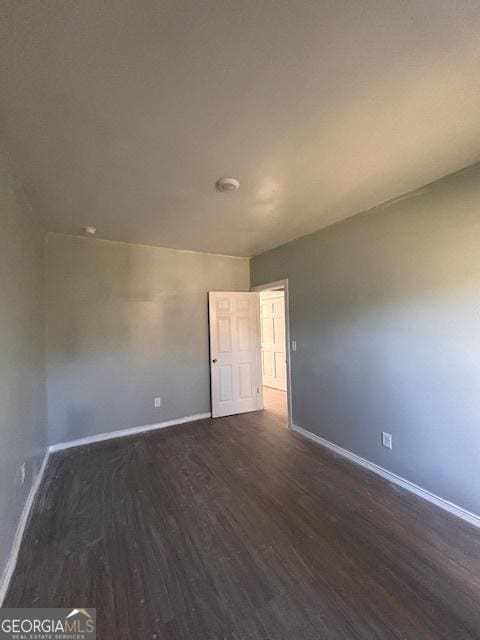 spare room featuring dark hardwood / wood-style floors