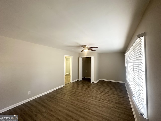 interior space featuring dark wood-type flooring and ceiling fan