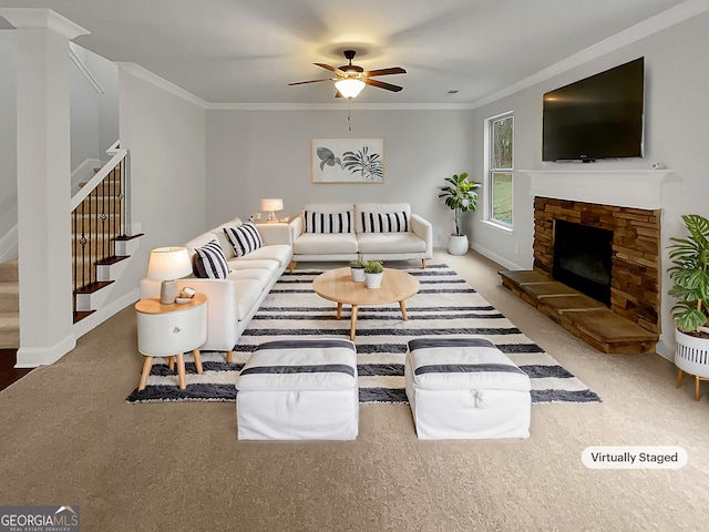 living room featuring crown molding, ceiling fan, and a stone fireplace