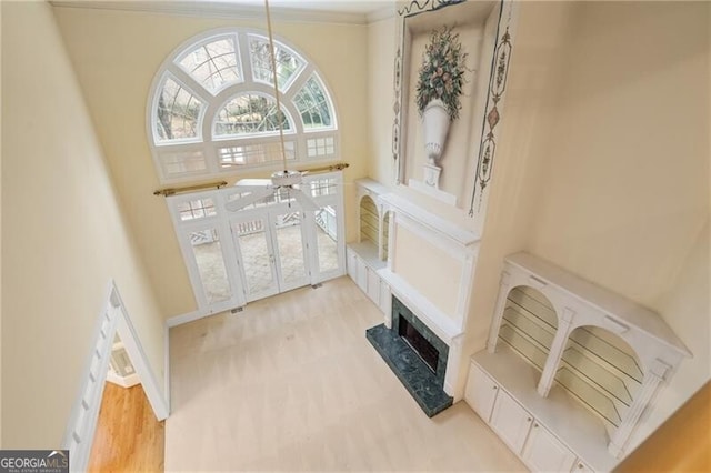 living room with crown molding and a towering ceiling