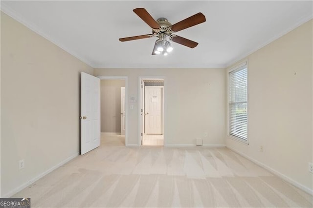 unfurnished bedroom with light carpet, crown molding, and ceiling fan