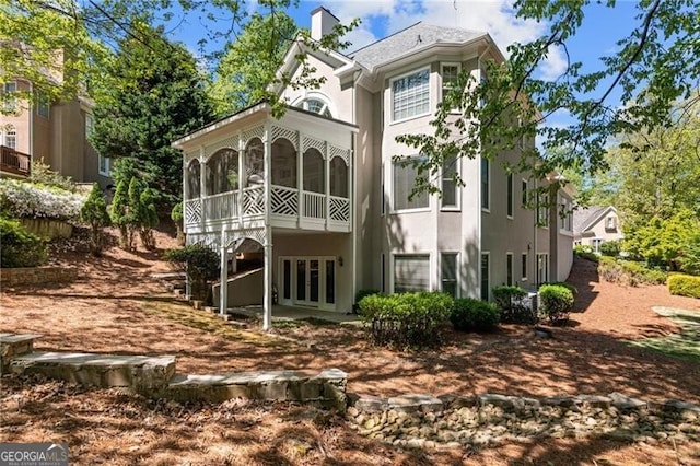 back of property featuring a sunroom