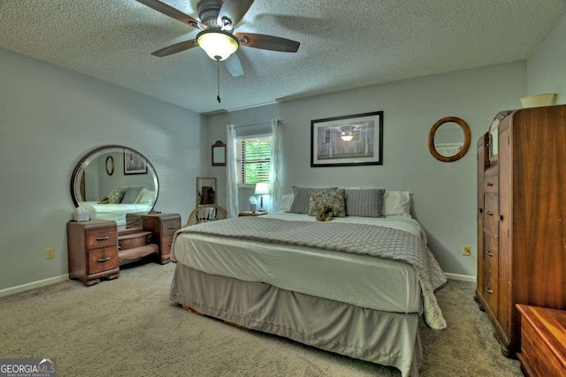 carpeted bedroom with ceiling fan and a textured ceiling