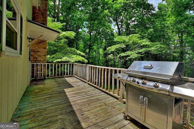 wooden deck featuring area for grilling