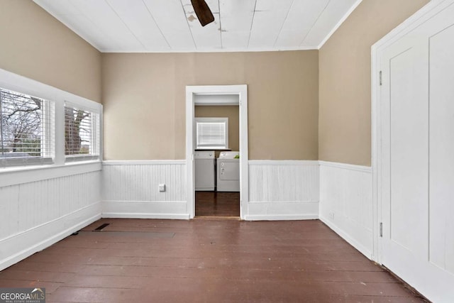 spare room with washer and clothes dryer, ornamental molding, and dark hardwood / wood-style floors