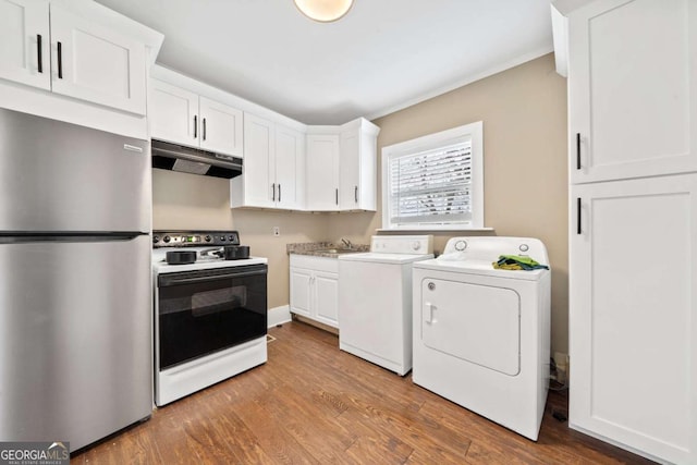 interior space with washing machine and dryer, sink, and light hardwood / wood-style floors