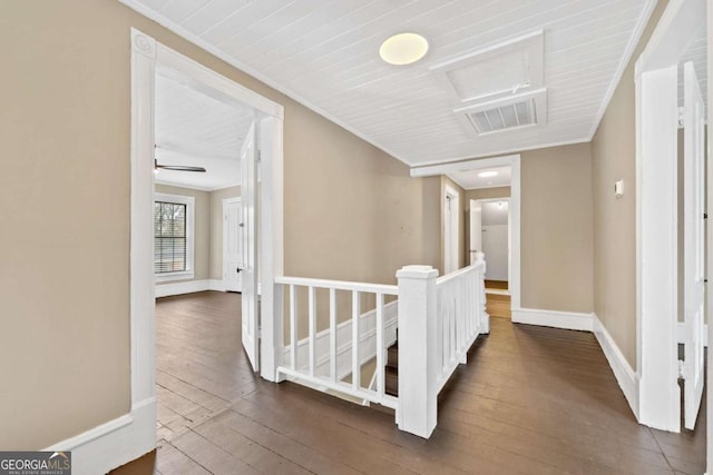 hallway with ornamental molding and dark hardwood / wood-style flooring