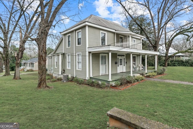 view of side of property with cooling unit, a yard, a balcony, and a porch