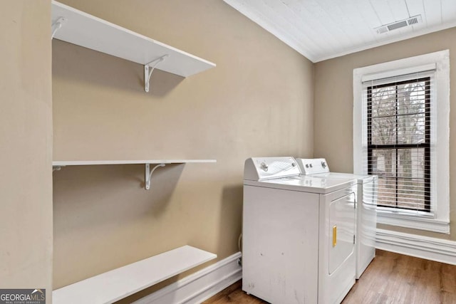 laundry room featuring hardwood / wood-style flooring and washer and clothes dryer