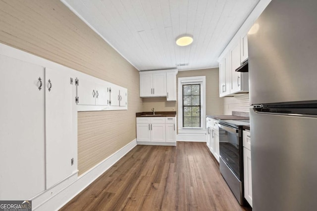 kitchen featuring dark wood-type flooring, appliances with stainless steel finishes, sink, and white cabinets