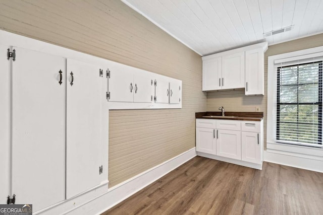 kitchen featuring wood ceiling, sink, hardwood / wood-style flooring, and white cabinets