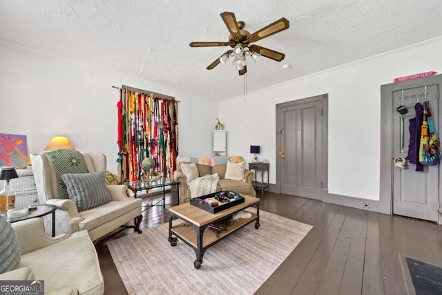 living room featuring ceiling fan, wood-type flooring, and a textured ceiling