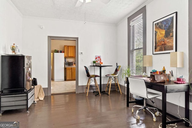 interior space featuring dark wood-type flooring, ornamental molding, and a textured ceiling