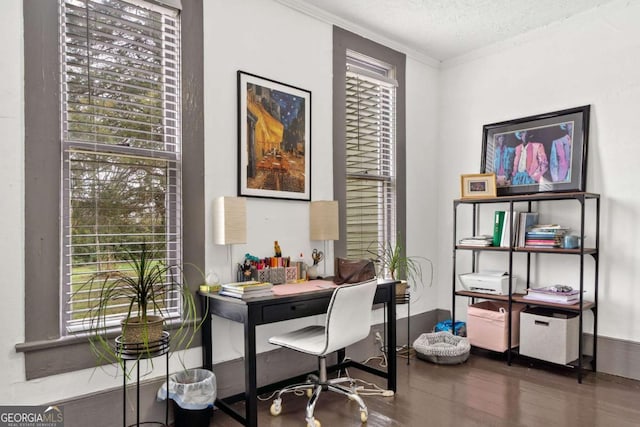 office area with crown molding, dark wood-type flooring, and a textured ceiling