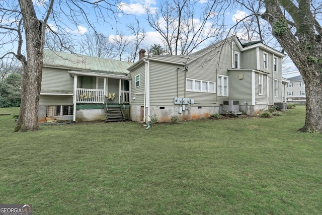 back of house with a yard, central AC, and covered porch