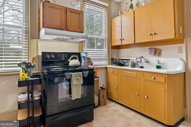 kitchen featuring black electric range oven and extractor fan