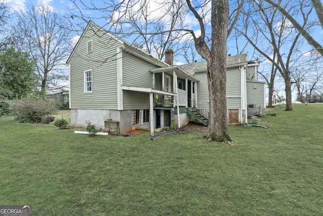 rear view of house with a lawn