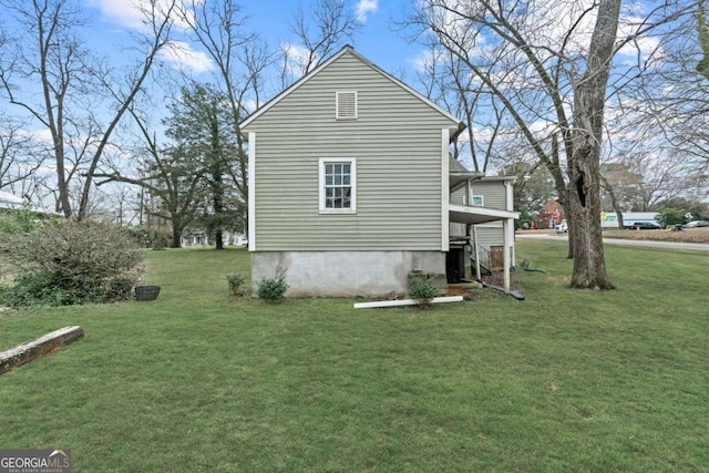 view of side of home with a yard