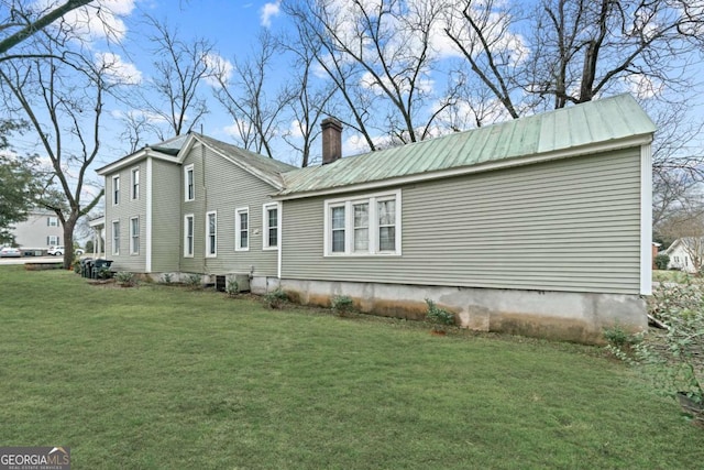 view of home's exterior with a lawn