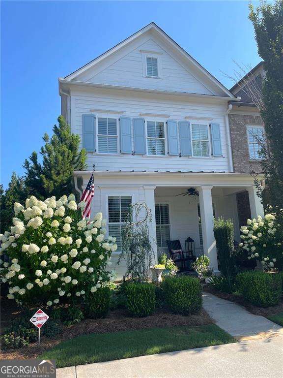 neoclassical home featuring a porch