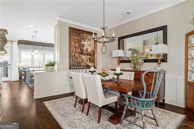 122 Brighton Blvd, Woodstock, GA 30188 - dining area featuring an inviting chandelier, dark wood-style flooring, ornamental molding, a decorative wall, and wainscoting