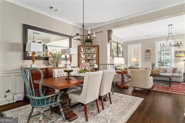 122 Brighton Blvd, Woodstock, GA 30188 - dining room with dark wood-style floors, wainscoting, visible vents, a notable chandelier, and crown molding