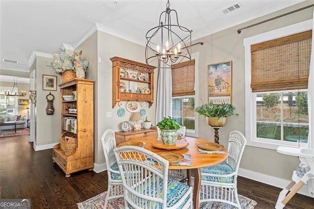 122 Brighton Blvd, Woodstock, GA 30188 - dining room featuring baseboards, a notable chandelier, crown molding, and dark wood-style flooring