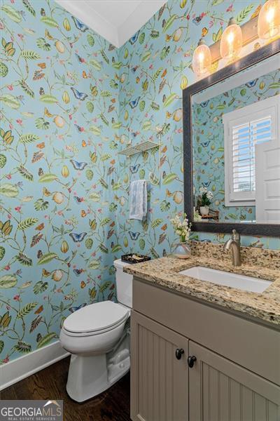 122 Brighton Blvd, Woodstock, GA 30188 - bathroom with toilet, baseboards, wood finished floors, and wallpapered walls