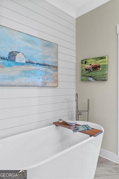 122 Brighton Blvd, Woodstock, GA 30188 - interior space with wood walls, a freestanding tub, and baseboards