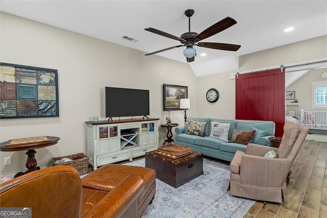 122 Brighton Blvd, Woodstock, GA 30188 - living room with a ceiling fan, a barn door, visible vents, lofted ceiling, and wood finished floors