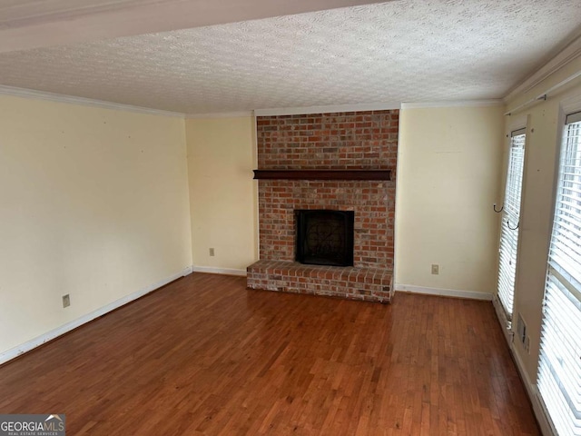 unfurnished living room featuring ornamental molding, a brick fireplace, and dark hardwood / wood-style floors