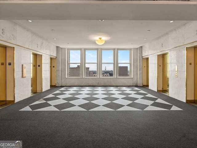 unfurnished room with elevator