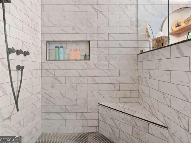 bathroom featuring tiled shower