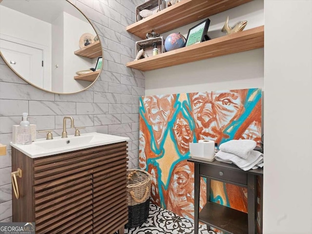 bathroom with vanity, tasteful backsplash, and tile walls