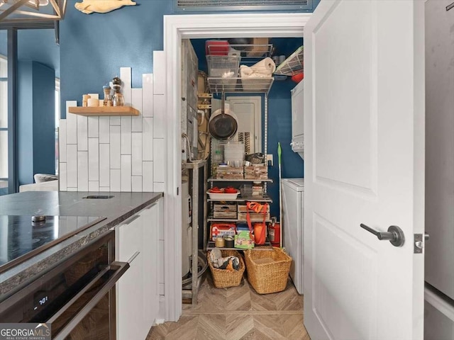 pantry with stacked washer and dryer