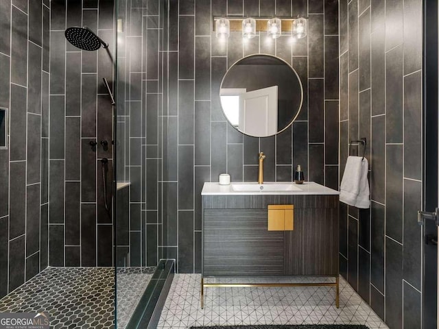 bathroom with vanity and a tile shower