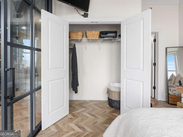 bedroom with light parquet flooring and a closet