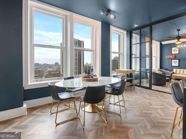 dining room featuring light parquet flooring and ceiling fan