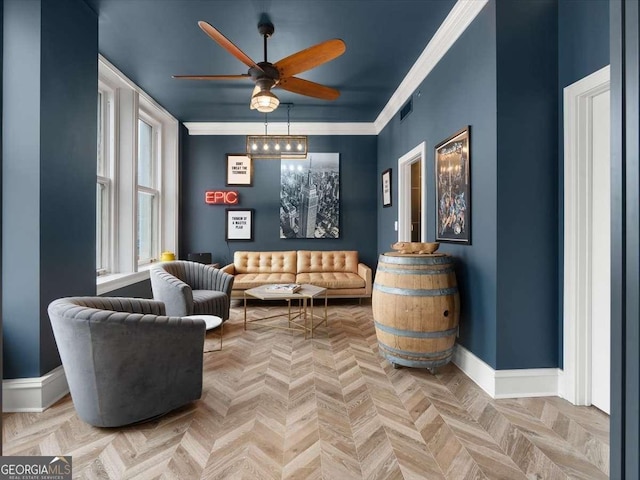 living area with ceiling fan, ornamental molding, and light parquet flooring