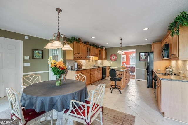 tiled dining room featuring sink and ornamental molding