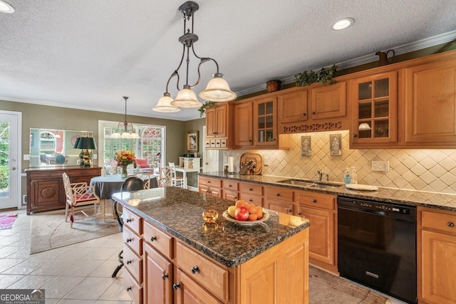 kitchen featuring a wealth of natural light, sink, dishwasher, a kitchen island, and hanging light fixtures