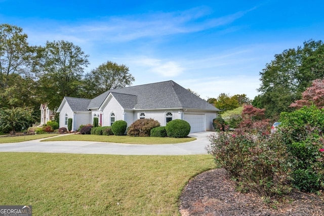 view of front of home featuring a garage and a front lawn