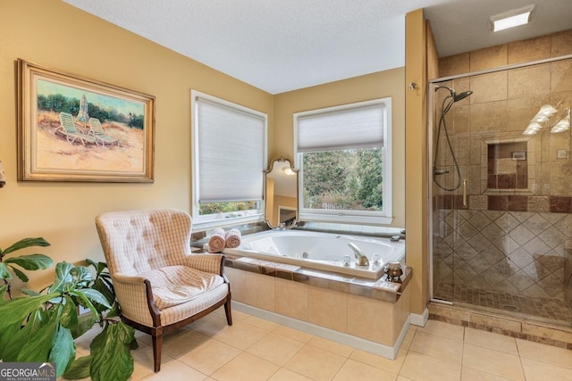 bathroom with plus walk in shower, tile patterned flooring, and a textured ceiling